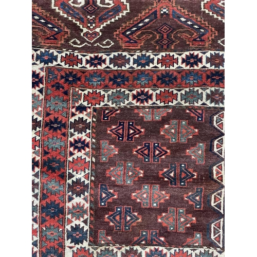 168 - A Yomut Haatchli rug, circa 1900, Turkmenistan. The madder field with quartered rectangular brown se... 