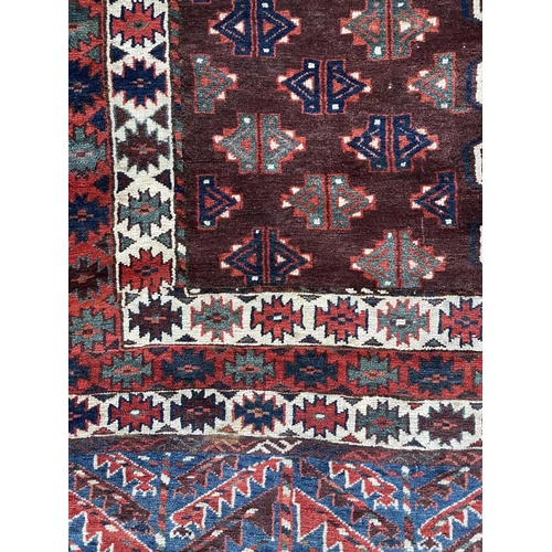 168 - A Yomut Haatchli rug, circa 1900, Turkmenistan. The madder field with quartered rectangular brown se... 