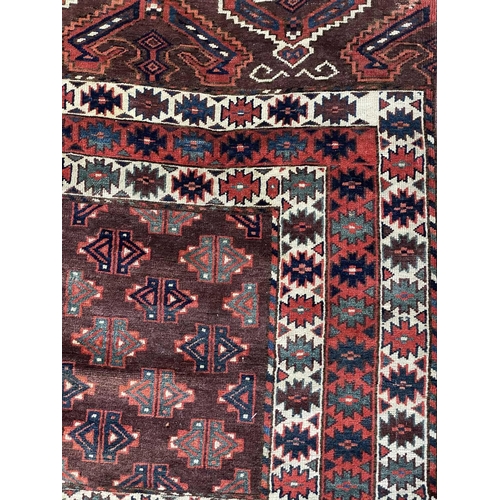 168 - A Yomut Haatchli rug, circa 1900, Turkmenistan. The madder field with quartered rectangular brown se... 