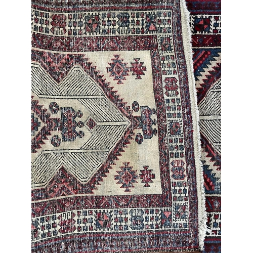 180 - A Sarab runner, North West Persia, circa 1930-1950. The camel field with three madder serrated pole ... 