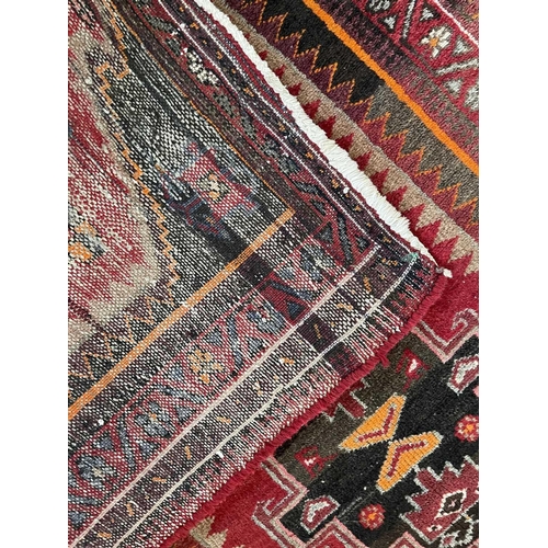 182 - A Hamadan rug, North West Persia, circa 1950's. With four central charcoal hooked medallions with bi... 