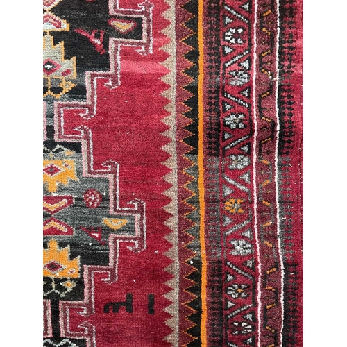 182 - A Hamadan rug, North West Persia, circa 1950's. With four central charcoal hooked medallions with bi... 