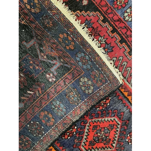 184 - A Hamadan rug, North West Persia, circa 1930's. The madder field with a central pale blue lozenge me... 