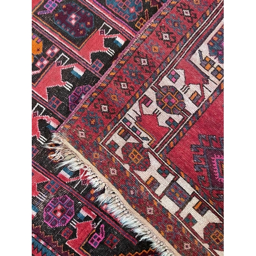 185 - A Hamadan carpet, North West Persia, mid 20th century. With a brown and charcoal abrash field, madde... 