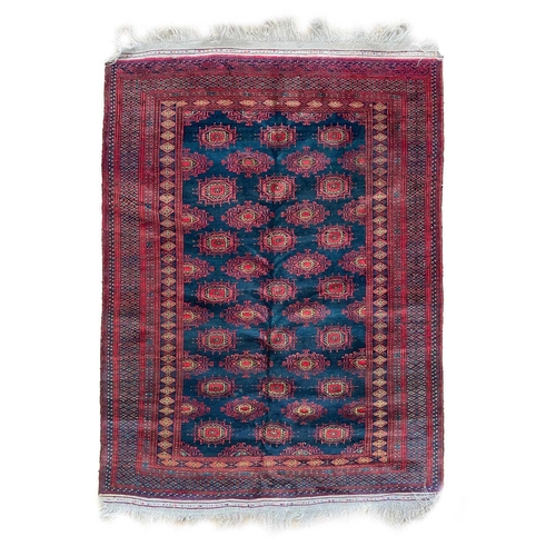 193 - A Pakistan rug, mid 20th century. The blue field with rows of multiple polychrome medallions, within... 