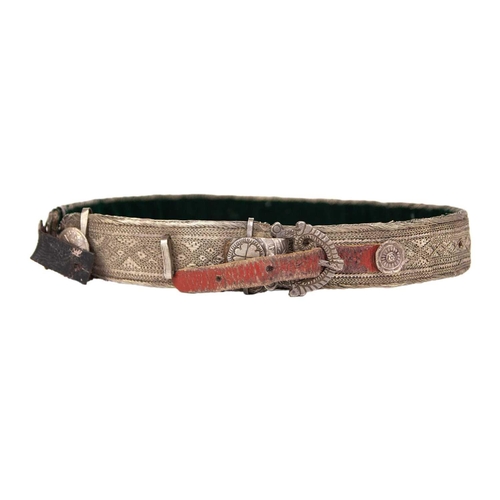 205 - A Persian white-metal belt, early 20th century. Length 69cm and a white-metal bangle. (2)