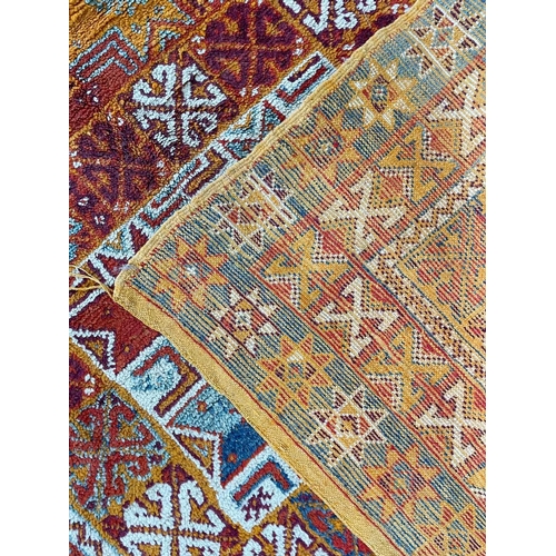 210 - A Moroccan rug, mid 20th century. The orange field with lesghi medallions and hooked guls, within mu... 