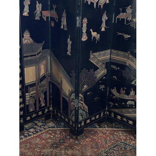 219 - A Chinese black lacquered screen, early 20th century. With eight panels, height 214cm.