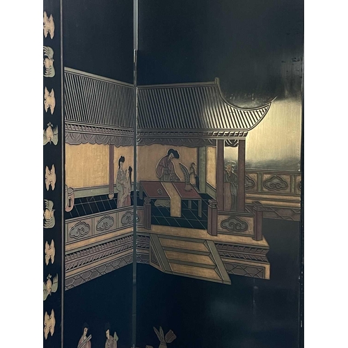 219 - A Chinese black lacquered screen, early 20th century. With eight panels, height 214cm.