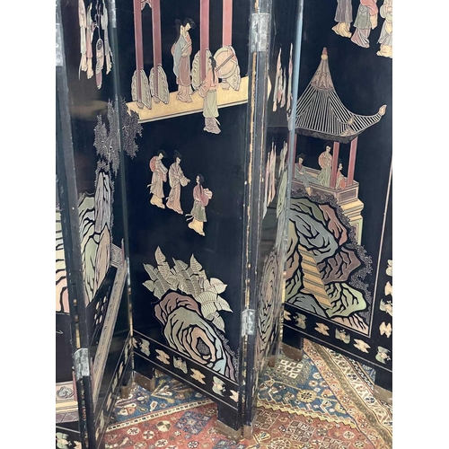 219 - A Chinese black lacquered screen, early 20th century. With eight panels, height 214cm.