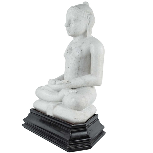 220 - An Indian Jain carved white marble figure of Jina, 19th century. Seated in double lotus on a cushion... 