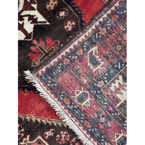 223 - A Hamadan rug, North West Persia, mid-late 20th century. The brown field with a large polychrome ser... 