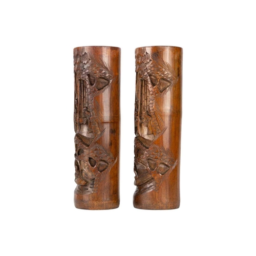 230 - A pair of Chinese bamboo brush pots, 19th century. Carved with figures in a landscape, trees and a f... 