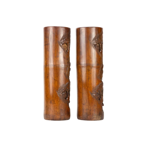 230 - A pair of Chinese bamboo brush pots, 19th century. Carved with figures in a landscape, trees and a f... 