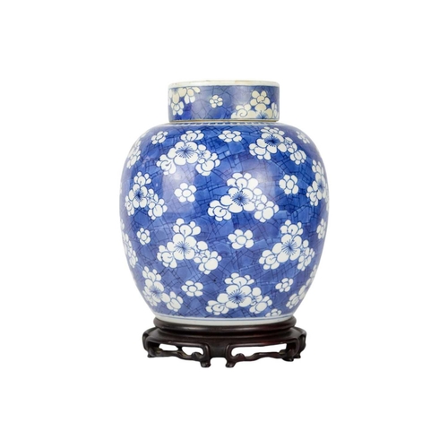 235 - A Chinese porcelain prunus pattern ginger jar and cover, 19th century. On a wooden stand, height 24c... 