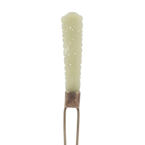 252 - A Chinese carved jade and white metal hairpin, early 20th century. Length 15.3cm, width 1.5cm and a ... 