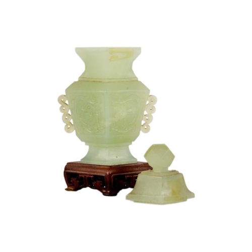 271 - A Chinese carved jade vase and cover Attached to a wooden stand, total height 19cm, width 9cm, depth... 