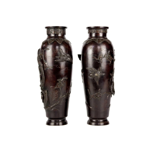 273 - A pair of Japanese bronze vases, Meiji Period. Decorated in high relief with birds, trees and foliag... 