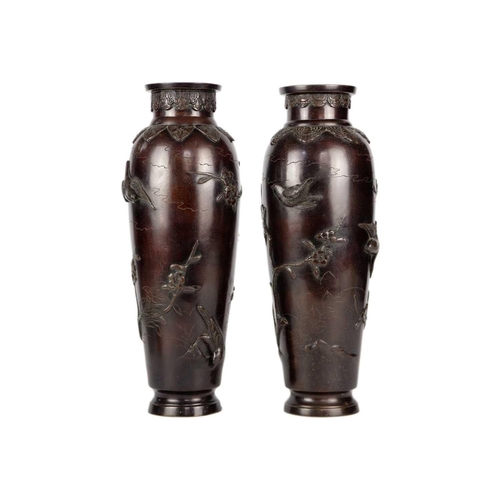 273 - A pair of Japanese bronze vases, Meiji Period. Decorated in high relief with birds, trees and foliag... 