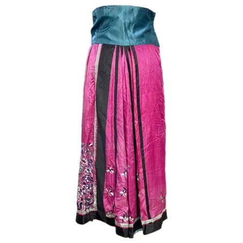 279 - A Chinese silk embroidered skirt, Qing Dynasty. The maroon skirt decorated with floral panels and sp... 