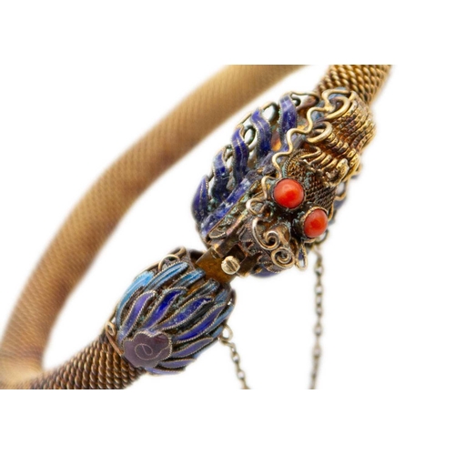 28 - A Chinese silver gilt and enamel dragon bracelet. With coral eyes, 8.5 x 8.5cm. The clasp doesn't ap... 