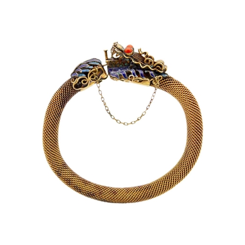 28 - A Chinese silver gilt and enamel dragon bracelet. With coral eyes, 8.5 x 8.5cm. The clasp doesn't ap... 