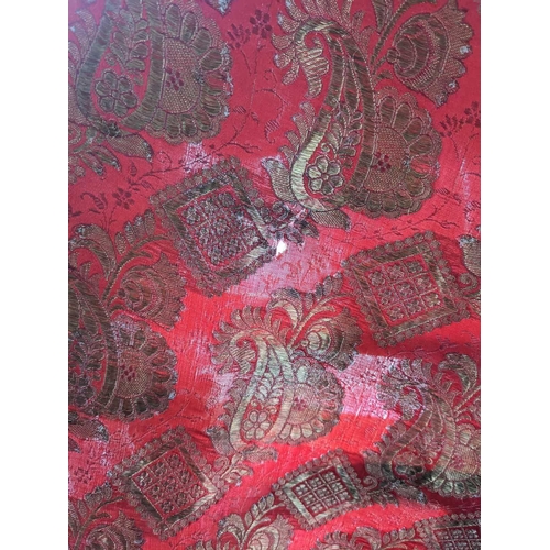 309 - An Indian silk paisley shawl, 20th century. The red ground decorated with a gold boteh design, withi... 