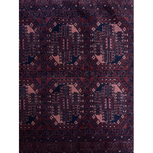 318 - An Afghan rug, circa 1920's. With five rows of two octagonal medallions, within multiple borders, 15... 