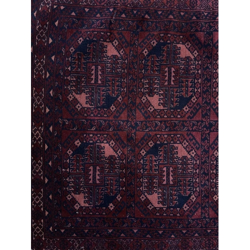 318 - An Afghan rug, circa 1920's. With five rows of two octagonal medallions, within multiple borders, 15... 