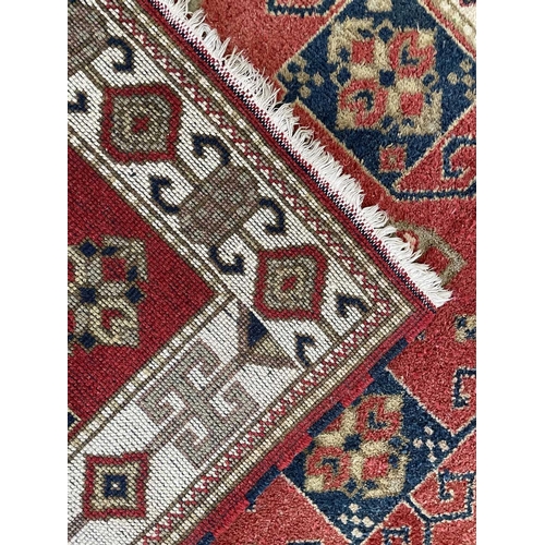 319 - A Ziegler Chobi rug, 20th century. The madder field with typical lesghi design, within an ivory hook... 