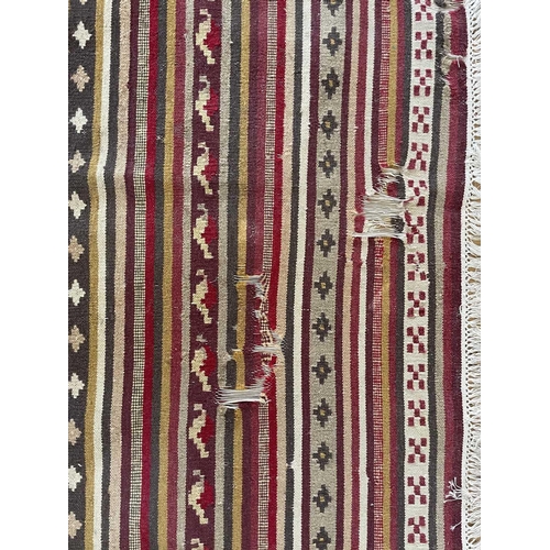 320 - A Persian kelim, 20th century. With multiple polychrome horizontal bands, 300 x 201cm.