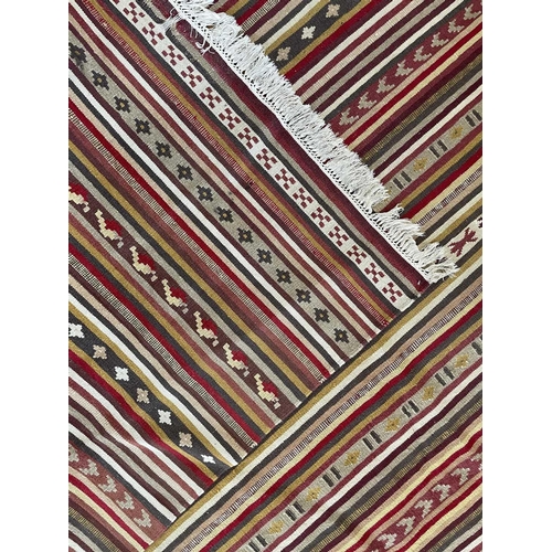 320 - A Persian kelim, 20th century. With multiple polychrome horizontal bands, 300 x 201cm.