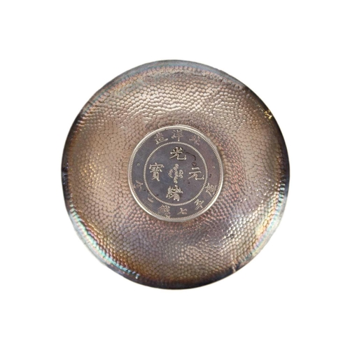 326 - A Chinese silver coin dish. The hammered dish with central set coin inscribed '29th year of Kuang Hs... 