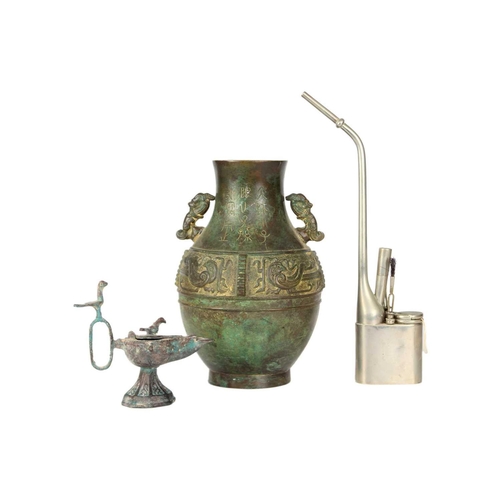 333 - A Chinese paktong opium pipe. Height 34cm, a cast iron oil lamp, height 13.5cm, a Chinese archaic st... 