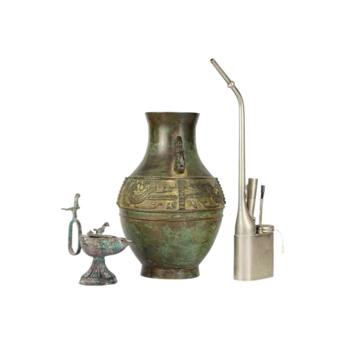 333 - A Chinese paktong opium pipe. Height 34cm, a cast iron oil lamp, height 13.5cm, a Chinese archaic st... 