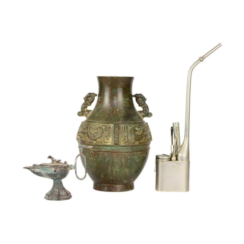 333 - A Chinese paktong opium pipe. Height 34cm, a cast iron oil lamp, height 13.5cm, a Chinese archaic st... 