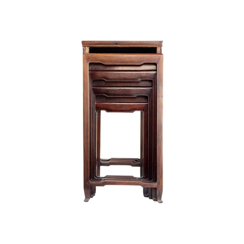 34 - A Chinese hardwood nest of four tables, early 20th century. Height 70cm, width 49cm, depth 35cm. The... 