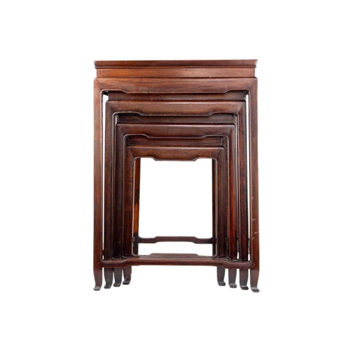 34 - A Chinese hardwood nest of four tables, early 20th century. Height 70cm, width 49cm, depth 35cm. The... 