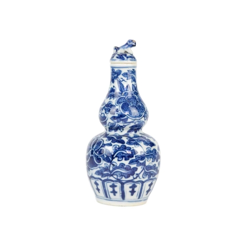 49 - A Chinese blue and white gourd vase, 19th century. Height 16.5cm, width 7.5cm. The cover has been gl... 