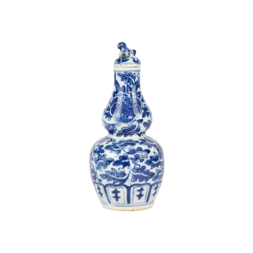 49 - A Chinese blue and white gourd vase, 19th century. Height 16.5cm, width 7.5cm. The cover has been gl... 