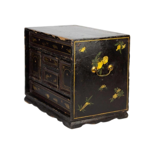 53 - A Japanese black lacquered table cabinet, 19th century. With an arrangement of six drawers, on brack... 