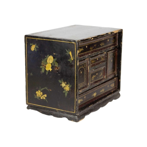 53 - A Japanese black lacquered table cabinet, 19th century. With an arrangement of six drawers, on brack... 