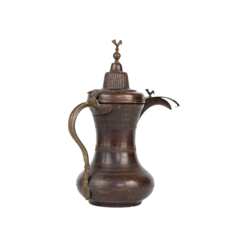 55 - A Saudi Arabian copper dallah pot, early-mid 20th century. Signed, height 30.5cm, width 27cm.