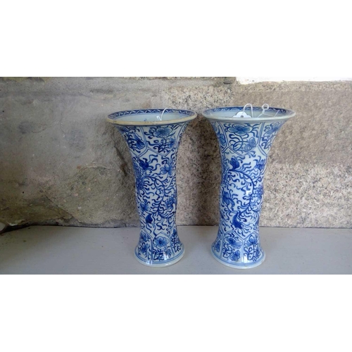 59 - A pair of Chinese blue and white gu vases, Kangxi period. Restored, height 20cm, diameter 11cm. (2) ... 