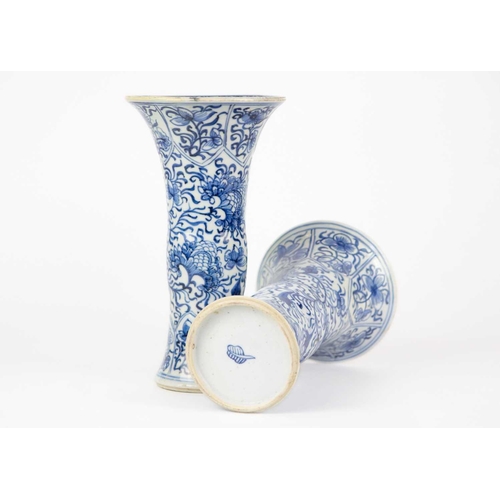 59 - A pair of Chinese blue and white gu vases, Kangxi period. Restored, height 20cm, diameter 11cm. (2) ... 