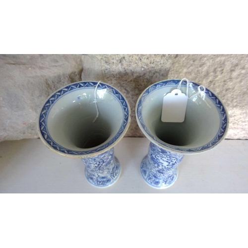 59 - A pair of Chinese blue and white gu vases, Kangxi period. Restored, height 20cm, diameter 11cm. (2) ... 