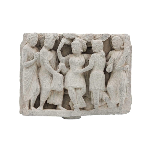 65 - A Gandharan carved schist panel, circa 3rd century. Depicting five female figures in robes, the cent... 