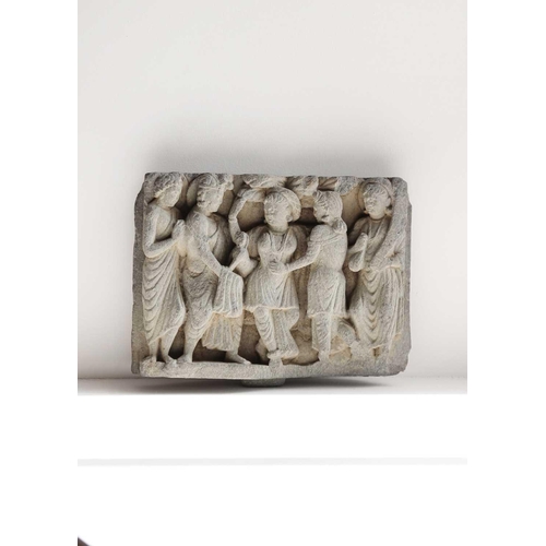 65 - A Gandharan carved schist panel, circa 3rd century. Depicting five female figures in robes, the cent... 