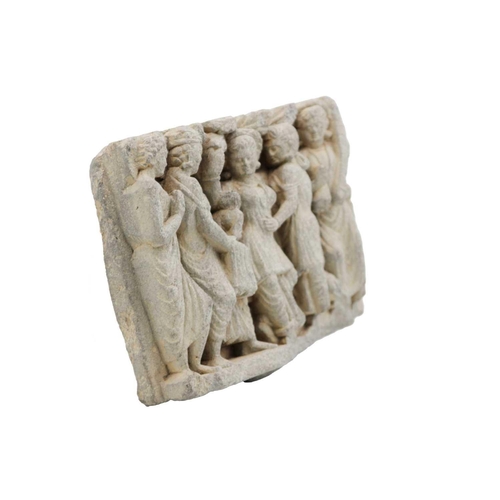 65 - A Gandharan carved schist panel, circa 3rd century. Depicting five female figures in robes, the cent... 