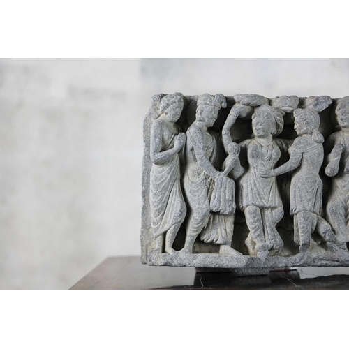 65 - A Gandharan carved schist panel, circa 3rd century. Depicting five female figures in robes, the cent... 